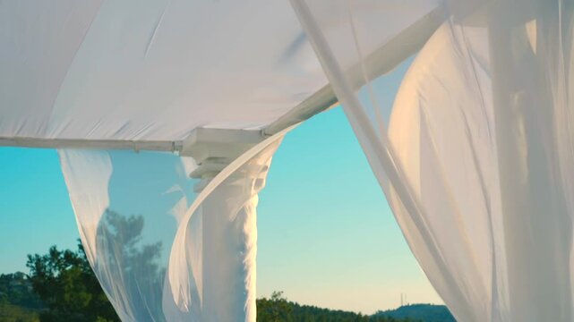 A beautiful white canopy with white flowers on the wedding day. High quality FullHD footage