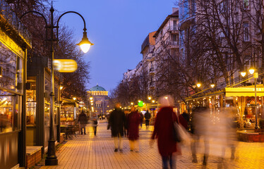 People walk along the evening busy Vitosha Boulevard in the city of Sofia, Bulgaria
