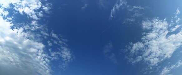 Vivid blue sky with fluffy clouds in a scenic panoramic view