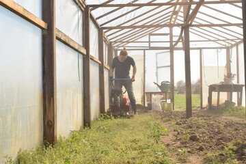Young man engaged in household chores and small-scale rural farming, tending to his garden with care and dedication. His daily routine reflects a sustainable and self-sufficient way of life