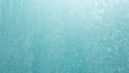 A textured light blue background showcases a slightly rough and aged surface with subtle variations in tone