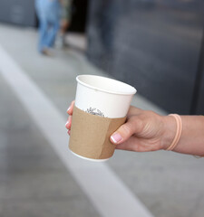 hand holding a cup of coffee