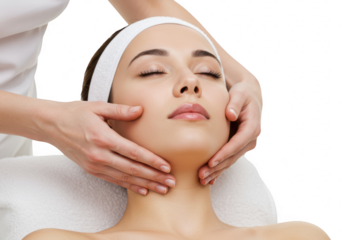 A beautiful woman is receiving a relaxing facial massage in a bright and clean spa
