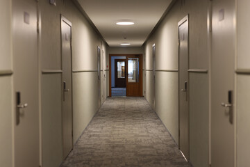 A modern hotel corridor with ambient lighting, stylish decor, and serene interiors for guests