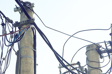 High-voltage concrete poles with power lines and insulators. Technical infrastructure of city...