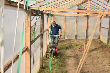 Young man engaged in household chores and small-scale rural farming, tending to his garden with care and dedication. His daily routine reflects a sustainable and self-sufficient way of life