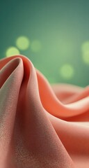 Soft, peach-toned fabric folds against a blurred teal background