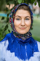 Beautiful woman in a traditional headscarf, summer outdoor