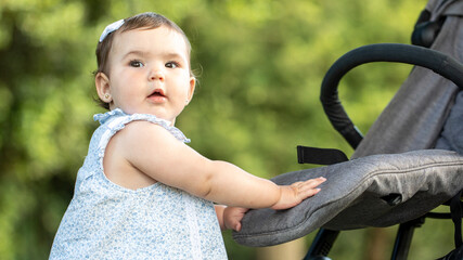 Baby in stroller outdoors in summer park