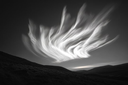 Dramatic black and white landscape photo featuring swirling clouds over rolling hills.