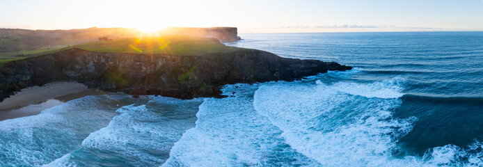 Sunset view from a drone of Antuerta Beach in Ajo, in the municipality of Bareyo, in the autonomous community of Cantabria, Spain. Europe