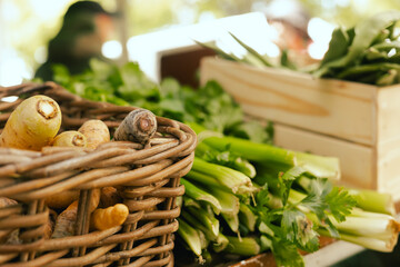 Fresh greens at small local urban market. Organic produce on sale at outdoor farmer market. Selling fresh crops and veggies harvest. European urban setting. Close up. Part of the series.