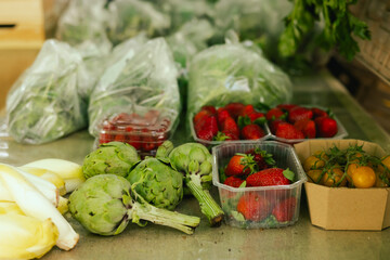 Fresh vegetables at small local urban market. Organic produce on sale at outdoor farmer market. Selling fresh crops and veggies harvest. European urban setting. Close up. Part of the series.