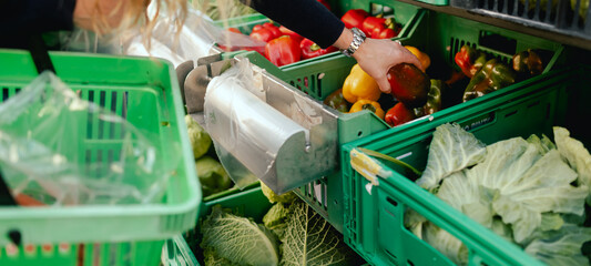 Close up of vegetables and greens in boxes and polyethylene bag on the local Farmers market....
