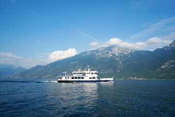 A typical Ferry boat on the Lake Garda in Italy with Mountains in the background