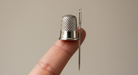 Thimble and Needle Resting on a Finger, Close-Up of Sewing Tools