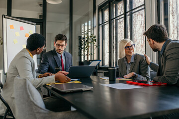 Business people having a meeting using laptop in the office