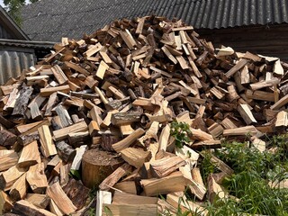 chopped firewood is stacked in a pile
