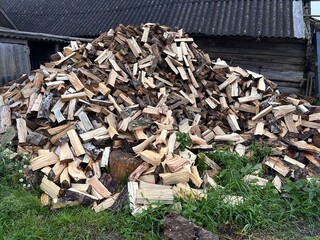 chopped firewood is stacked in a pile
