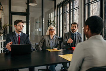 Recruitment team interviewing job applicant in modern office