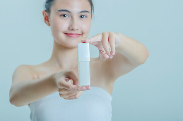 Hands Applying Skincare Product with Pump Bottle