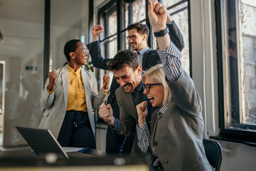 Excited business team celebrating success in the office