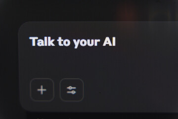Talk to your AI prompt displayed on a dark digital interface panel with plus and settings icons...