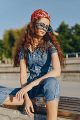 Modern boho-western denim street style woman wearing blue denim outfit and large sunglasses in...