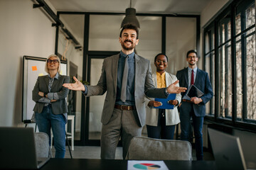 Business team celebrating success in modern office after corporate meeting