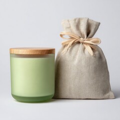 Light green frosted glass candle with wooden lid, beside a linen bag
