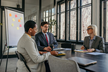 Businesspeople having meeting discussing strategy in office boardroom