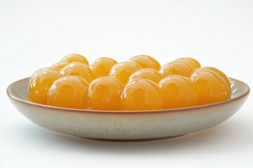 Close-up of Bright Orange Tapioca Pearls in Bowl orange close-up bowl bright tapioca pearls yellow