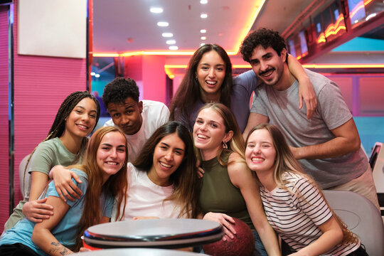 Group of happy multi ethnic friends is smiling and having fun together at bowling alley
