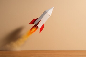 Paper rocket with red fins taking off on wood surface symbolizing creativity innovation and project growth launch