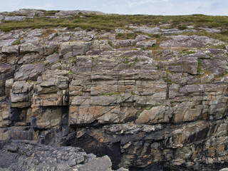 Detailed view of layered rock formations with fractures at Sheeps Head, Ireland, capturing natures artistry.