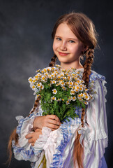 Smiling girl in vintage dress holding bouquet of daisies on dark background