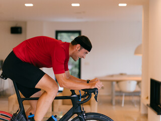 Triathlete Man Cycling on Stationary Bike at Home