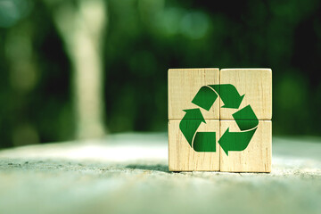 Green Recycling Symbol on wooden block. Concepts of reducing and reusing, environmentally friendly products, CSR, zero waste. with copy space