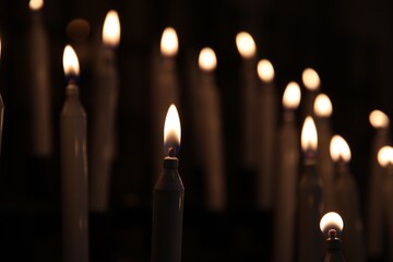 Serene lit candles in a dim setting.
