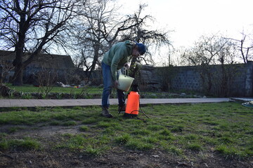 Young man engaged in household chores and small-scale rural farming, tending to his garden with care and dedication. His daily routine reflects a sustainable and self-sufficient way of life