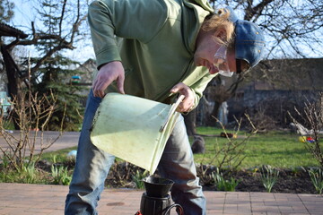 Young man engaged in household chores and small-scale rural farming, tending to his garden with care and dedication. His daily routine reflects a sustainable and self-sufficient way of life