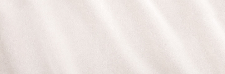 New light beige wavy soft suede fabric background. Closeup. Wide banner. Top down view.