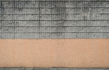 Brick wall with gray bricks and brown bottom