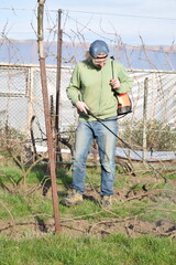 Young man engaged in household chores and small-scale rural farming, tending to his garden with care and dedication. His daily routine reflects a sustainable and self-sufficient way of life
