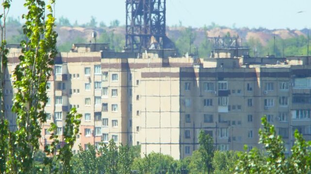 Extreme summer heat wave causes heavy atmospheric distortion over residential buildings in industrial Ukrainian city. Air refraction creates shimmering mirage effect. Global warming concept video