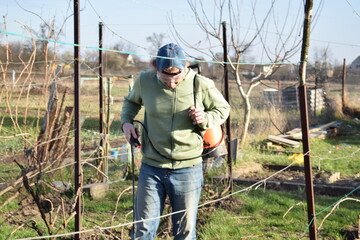 Young man engaged in household chores and small-scale rural farming, tending to his garden with care and dedication. His daily routine reflects a sustainable and self-sufficient way of life