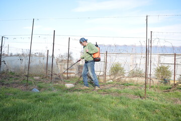 Young man engaged in household chores and small-scale rural farming, tending to his garden with care and dedication. His daily routine reflects a sustainable and self-sufficient way of life