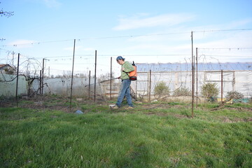 Young man engaged in household chores and small-scale rural farming, tending to his garden with care and dedication. His daily routine reflects a sustainable and self-sufficient way of life