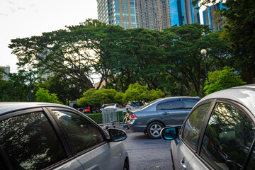 Outdooor car parking lot in city public park with tree