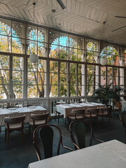 Elegant restaurant interior with served tables and large windows